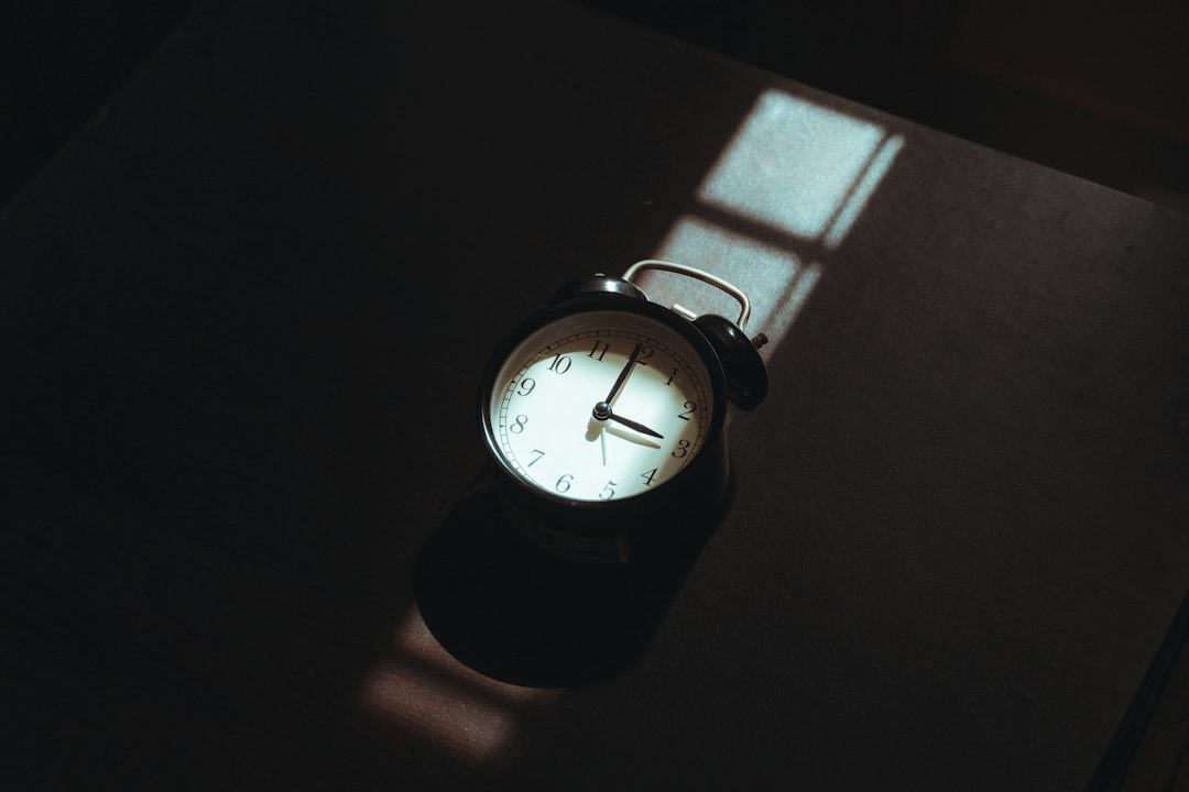 Alarm clock on a dark surface, illustrating Sweeps Coin inactivity deadlines.