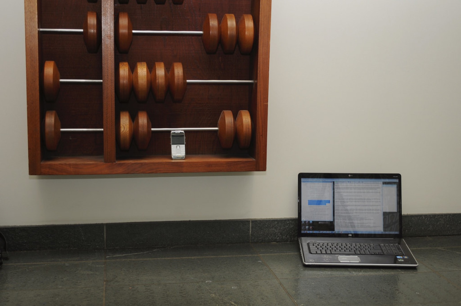 Wooden abacus beside a laptop, illustrating minimum Sweeps Coins redemption amounts
